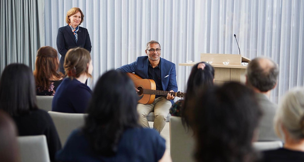 man playing guitar and funeral reception