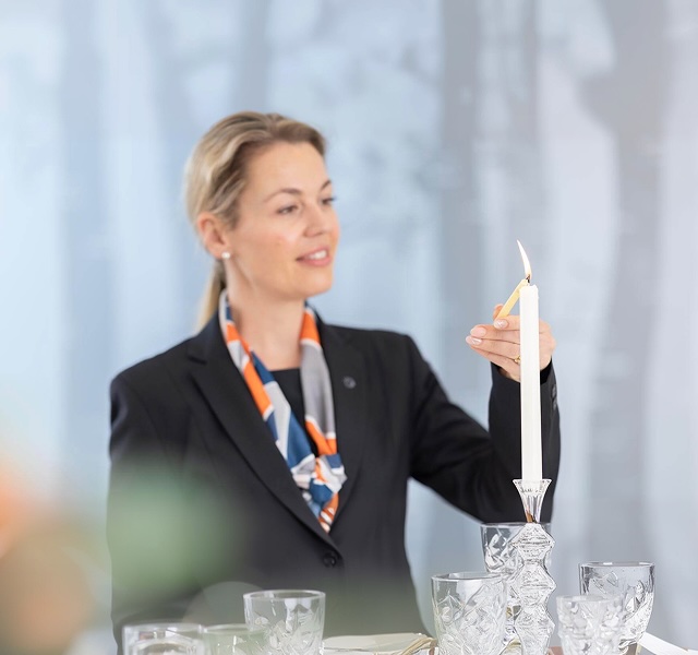 funeral director lighting candle