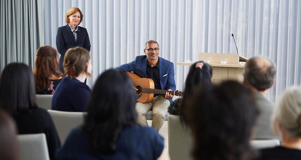 man playing guitar and funeral reception